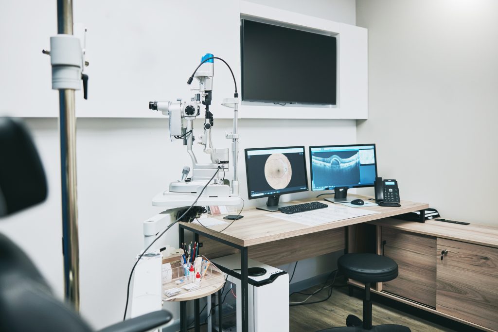 Ophthalmology, computer and empty room with equipment for vision, healthcare and consultation. Tech.